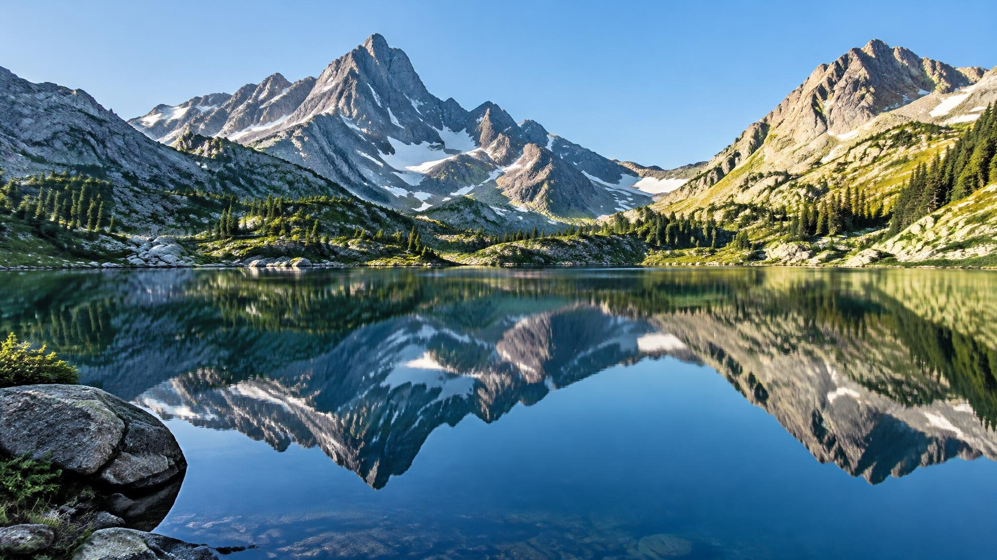Mountain lake with rocky peaks and still water