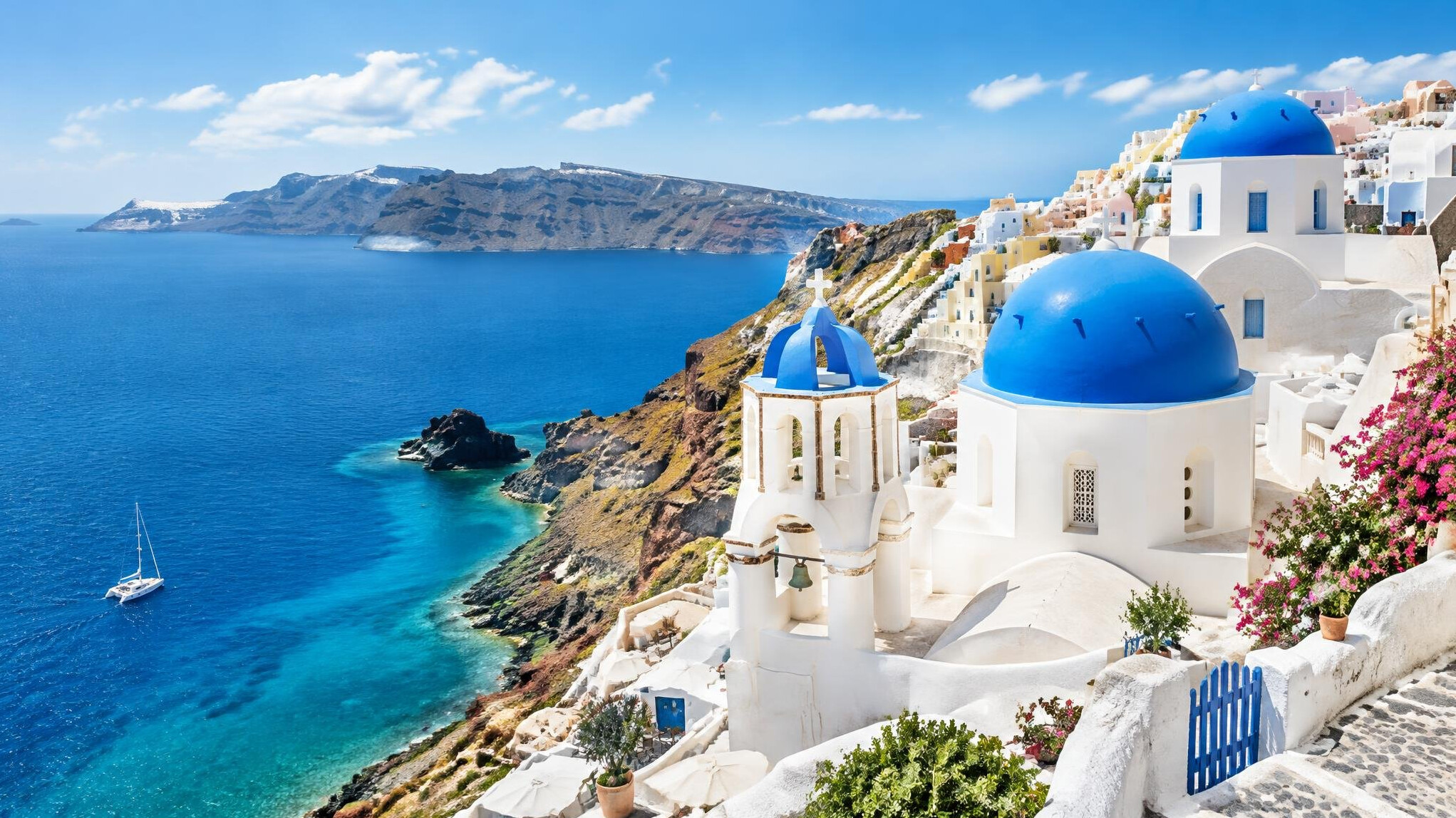 White houses with blue domes above the Aegean Sea in Santorini