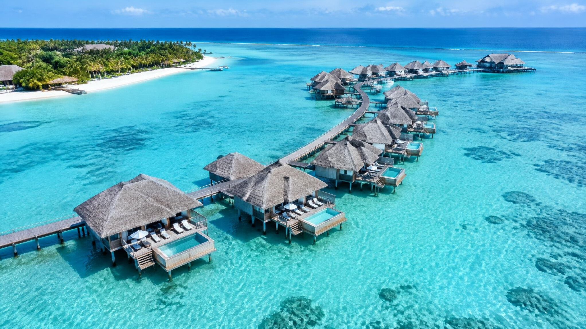 Overwater villas on a turquoise lagoon in the Maldives